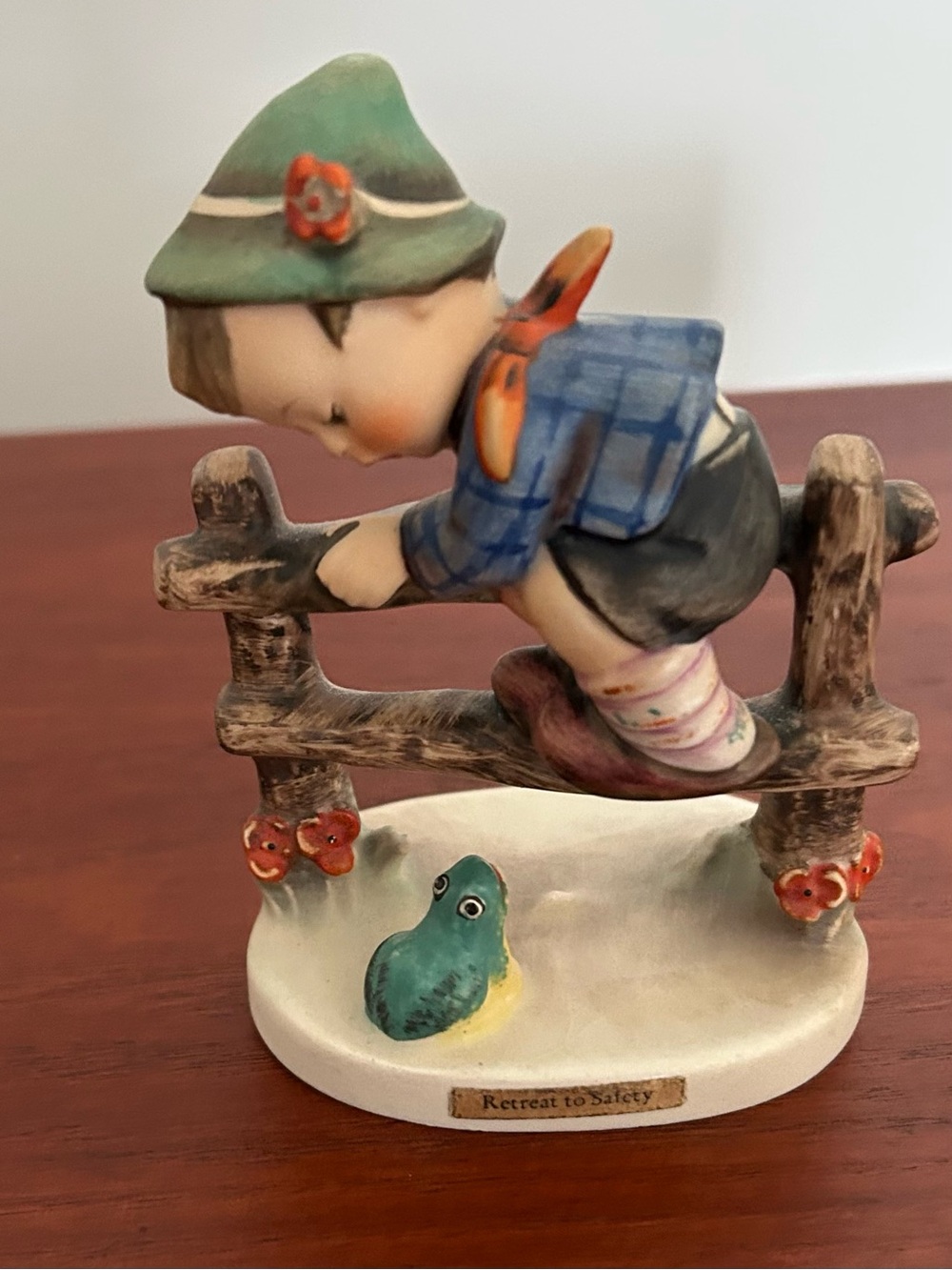 Hummel Boy on Fence Figurine with Green Hat and Blue Jacket